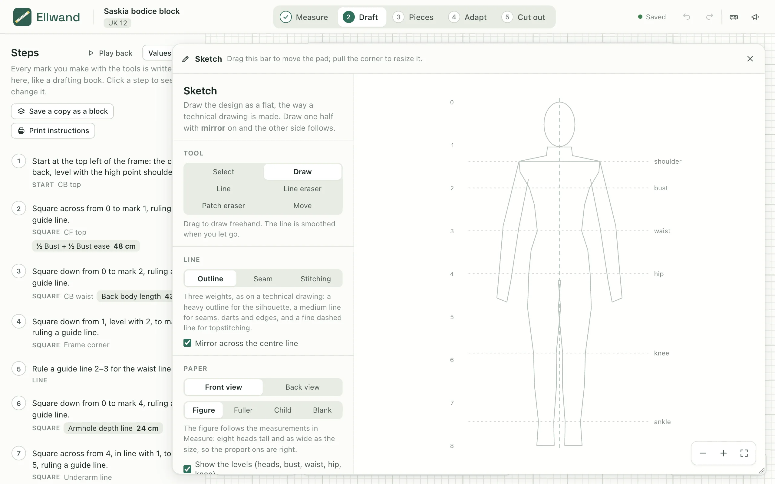 The sketch pad open over the draft, with a figure to draw over